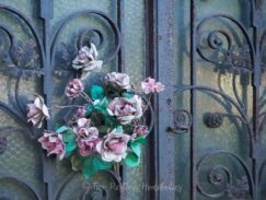 Faded flowers on a crypt at Pere Lachaise
