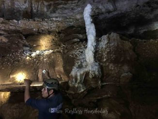 Guide Wilmer shows luminescent rock while cave tubing in Belize