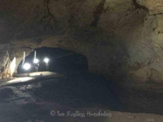 Headlamps walking through Footprint Cave