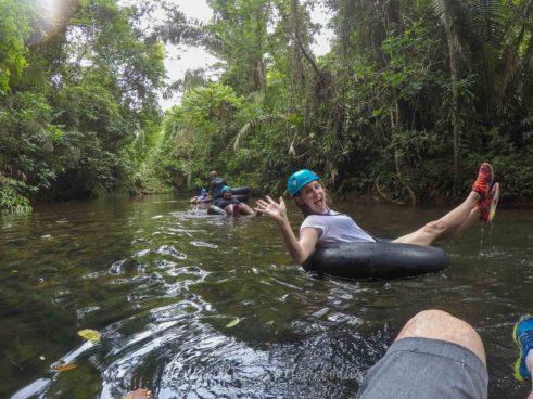 Floating down the river to Footprint Cave while cave tubing in Belize
