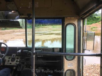 School bus/tour bus for cave tubing in Belize crossing a river