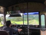 School bus/tour bus for cave tubing in Belize driving through orange grove