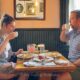 Luke and Meagan sipping coffee at the breakfast table at Tarrant's cafe in Richmond VA